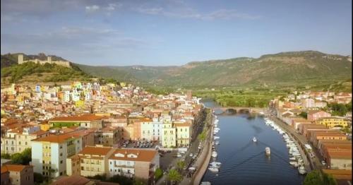 a view of a city with a river and buildings at La Dea Hestia in Bosa