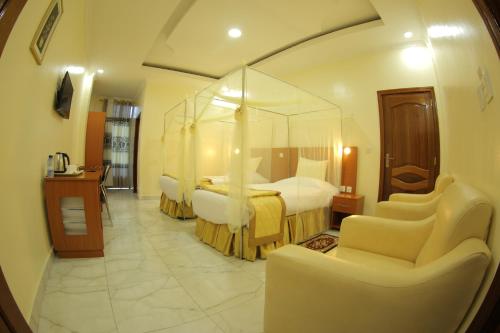 a hotel room with a bed with a canopy at Fatima Hotel in Ruhengeri