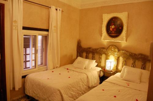 a bedroom with two beds and a window at Riad Palais Des Princesses & Spa in Marrakesh