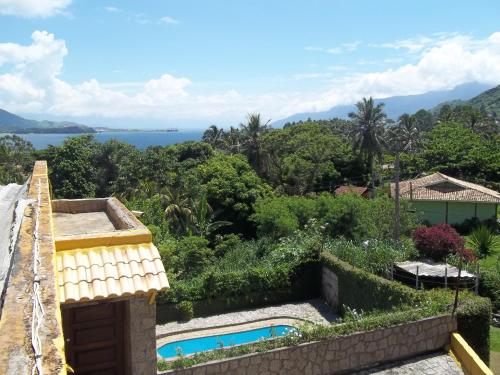 a view from the balcony of a house with a swimming pool at Pousada TRUFFIMAR Ilhabela in Ilhabela