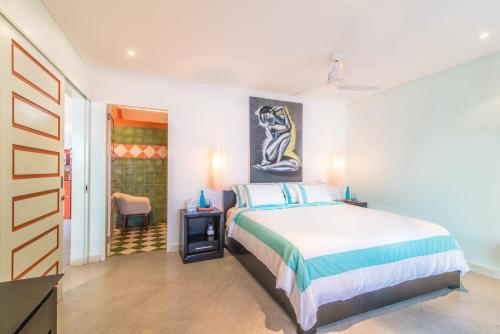 a bedroom with a large bed in a room at Villa Majorelle Bali in Seminyak
