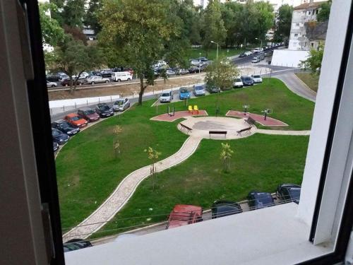 a view from a window of a park with cars at Best house airport lisbon in Lisbon