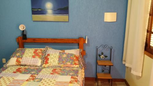a bedroom with a bed with a quilt on it at Estúdio Recanto Dos Anjos in Arraial do Cabo