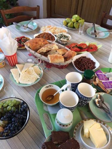 a table topped with lots of different types of food at Guesthouse Raisa in Kvareli
