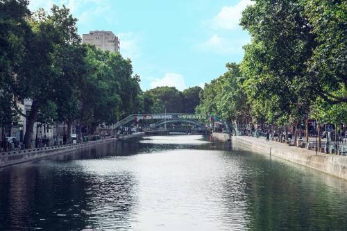 a river with a bridge in a city at Timhotel Paris Gare de l'Est in Paris