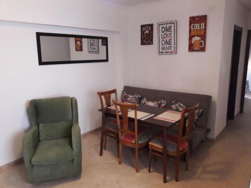 a dining room with a table and a chair at Apartamento Avenida Parque in Córdoba