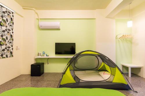 a room with a tent and a tv in it at Nice Guanxi in Guanxi
