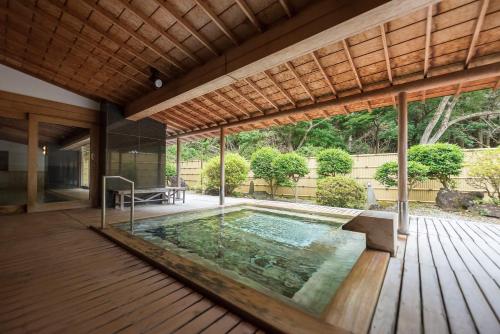 a swimming pool in the middle of a house at Nishiizu Crystal View Hotel in Nishiizu