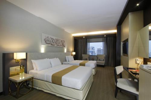 En eller flere senge i et værelse på Royal Benja Hotel