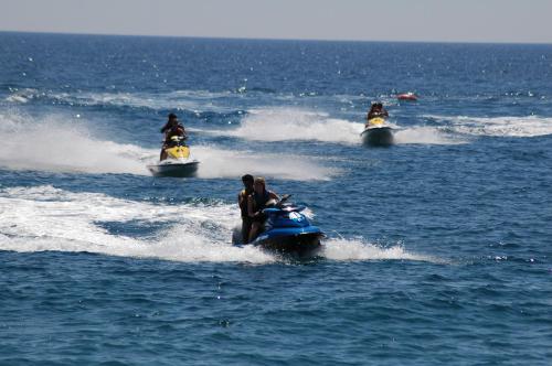 a group of people riding on a jet ski in the water at Utopia World in Mahmutlar