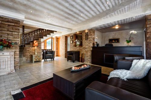 a living room with a couch and a table at Velinov Boutique Hotel in Bansko