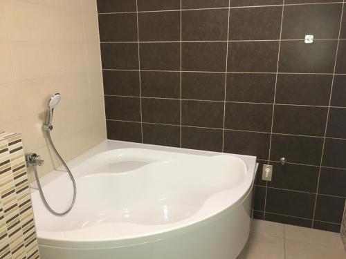 a bath tub in a bathroom with a shower at Apartmán Donovaly, Panorama in Donovaly