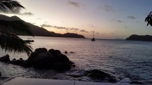 a view of the ocean with a boat in the water at Coin D'or in Anse Possession