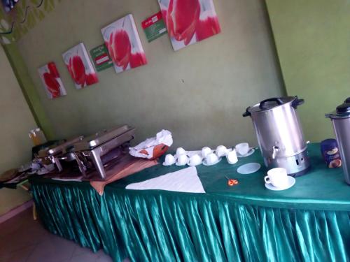 a green table with a mixer and cups on it at Lambada Holiday Resort Mombasa in Mtwapa