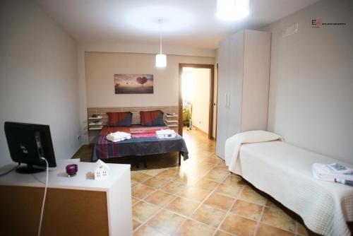 a room with two beds and a tv in it at ARAS b&b - in Mazzarino