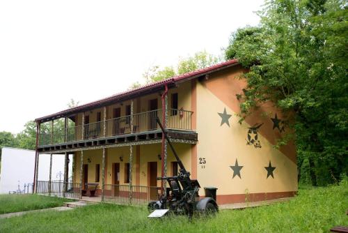 a house with a motorcycle parked in front of it at Arsenal Park Transilvania in Orăştie