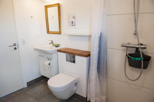 Baño pequeño con aseo y lavamanos en Tikob Go to Sleep en Tikøb