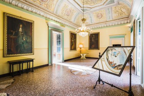 an art exhibit in a room with a painting at Palazzo Barbò in Pumenengo