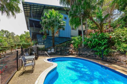 a swimming pool in front of a house at Panorama Apartments on Hamilton Island by HIHA in Hamilton Island