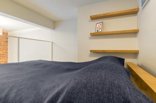 a bedroom with a large bed and shelves at Stay Apartments 14 in Tallinn