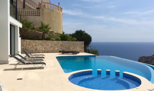 a swimming pool with a view of the ocean at Villa Priscilla in Jávea