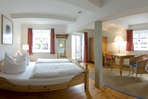 クヴェードリンブルクにあるHotel Pension St Nikolaiのベッドルーム(木製ベッド1台付)、リビングルームが備わります。
