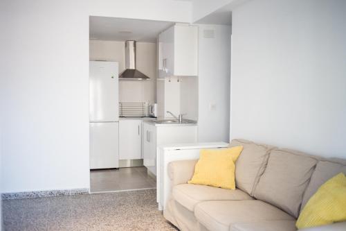 a living room with a couch and a yellow pillow at MyFlats Voramar in El Campello