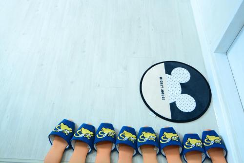 a sign and a row of blue and yellow shoes at Residence Unicorn in Seoul