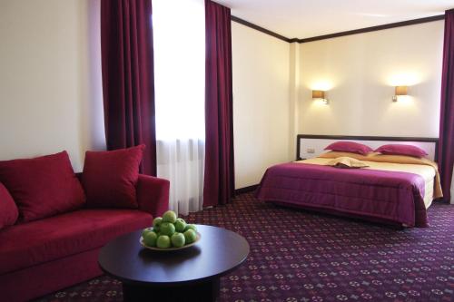 a hotel room with a bed and a couch at Park-Hotel Golosievo in Kyiv