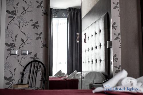 a room with a table and a mirror and a room with a table at Hotel Relax Roma Nord in Fiano Romano