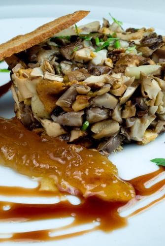 a plate of food with mushrooms and sauce at Palacio de Cutre in La Goleta