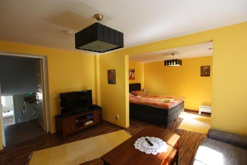 a living room with a bed and a tv in it at Virulase Holiday Home in Toila