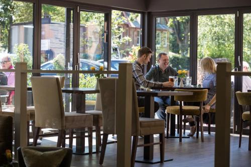 a group of people sitting at a table in a restaurant at Nether Abbey Hotel in North Berwick