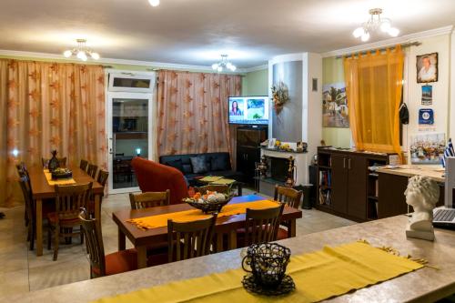 a kitchen and living room with tables and chairs at Anestis Studios in Lidia