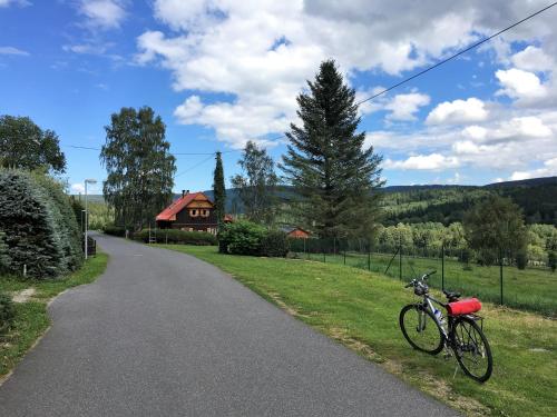 a bike parked on the side of a road at Apartmán u lesa, Srní 119 in Srní