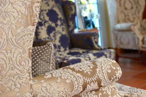 a blue and white chair with a pillow at Hotel Der Lindenhof in Gotha