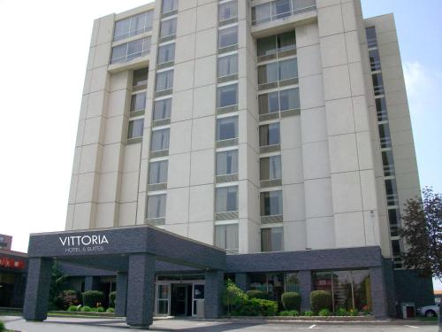 a large building with a large window at Vittoria Hotel & Suites in Niagara Falls