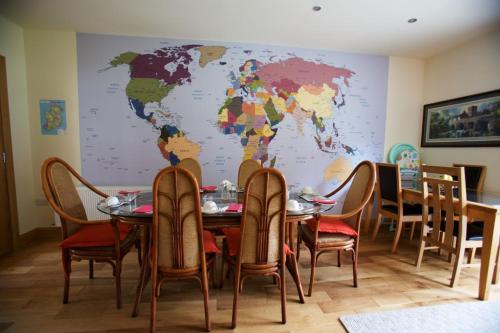 a dining room with a map of the world on the wall at Woodview House Bed and Breakfast in Cork