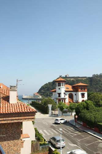 a view of a street with cars parked on the road at Hotel Verdemar in Ribadesella