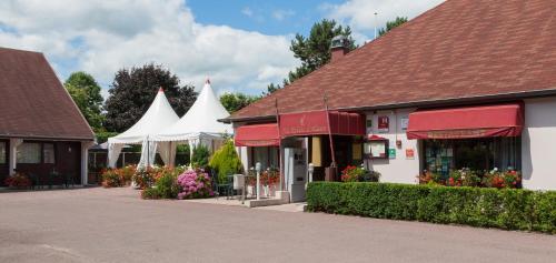 a group of buildings with red and white roofs at Hôtel Restaurant Au Relais D'Alsace in Rouffach