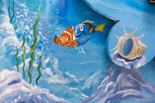 a painting of a clown fish in a aquarium at Elisa House in Jian