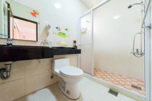 a bathroom with a toilet and a shower at Elisa House in Jian