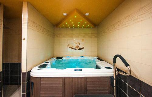 a bathroom with a jacuzzi tub in a room at Penzión Zivka in Závažná Poruba