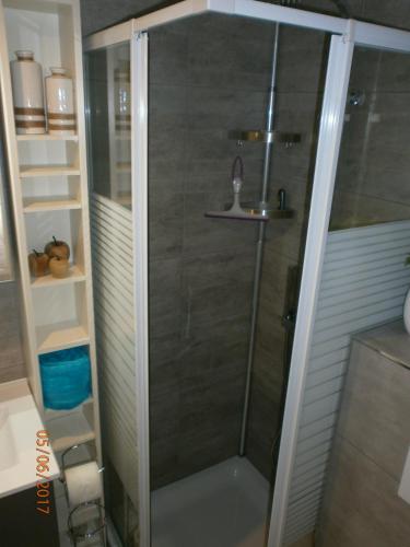 a shower with a glass door in a bathroom at Vakantiehuisje Bredene in Bredene