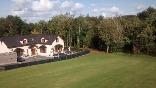 an aerial view of a house with a green yard at Woodview House Bed and Breakfast in Cork