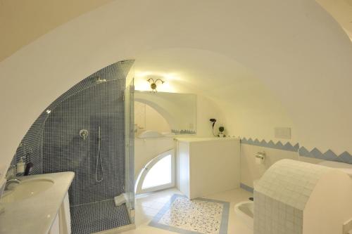 a bathroom with a shower and a toilet and a sink at Surriento Suites in Sorrento