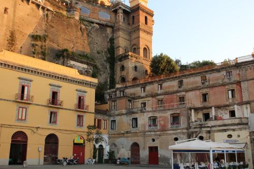 a group of buildings in front of a mountain at Surriento Suites in Sorrento