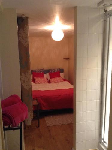 a bedroom with a bed with red pillows at Sea breeze holiday apartment in Weymouth