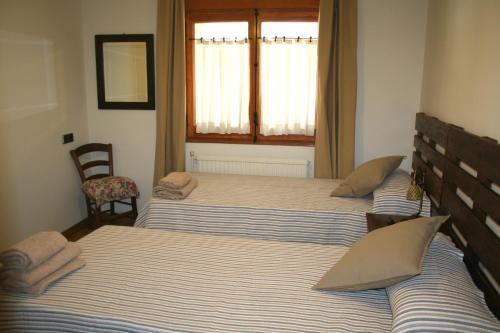 Ένα ή περισσότερα κρεβάτια σε δωμάτιο στο Apartament Ca l'Emilia