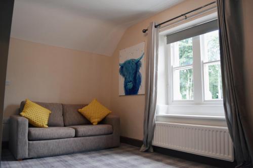 a living room with a couch and a window at The Apple Inn in Lucker